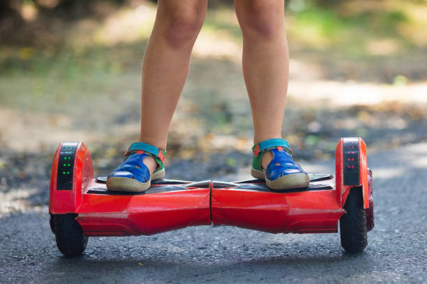 istock Child on hover board. Kids ride scooter. 915882020