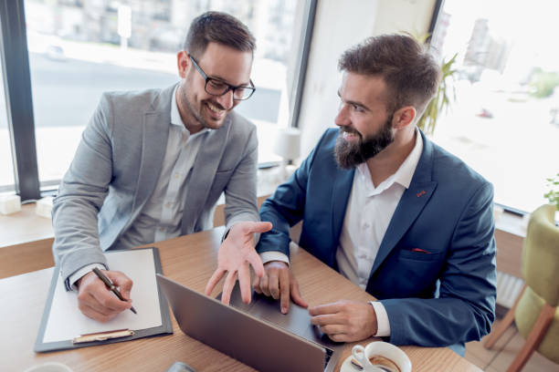 istock Young business people using laptop and drink coffee. 915886760