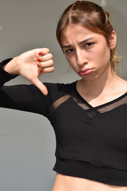 istock Girl With Thumbs Down 915889592