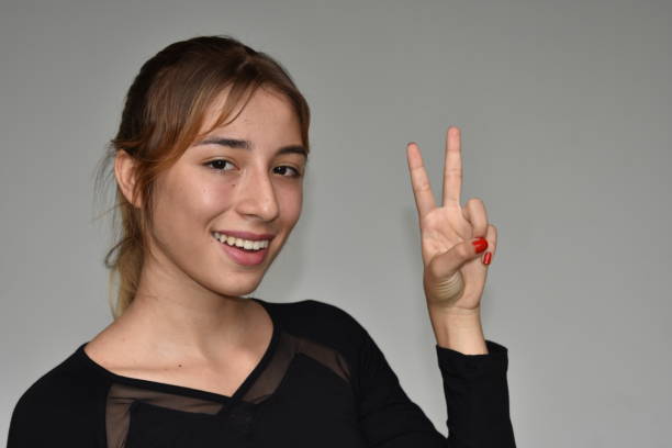 istock Minority Female And Peace Sign 915889726