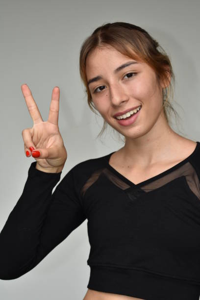 istock Latina Female And Peace Sign 915889960
