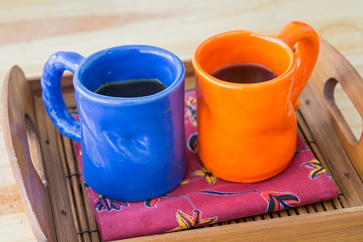 Two cups of coffee in a tray with cloth napkin
