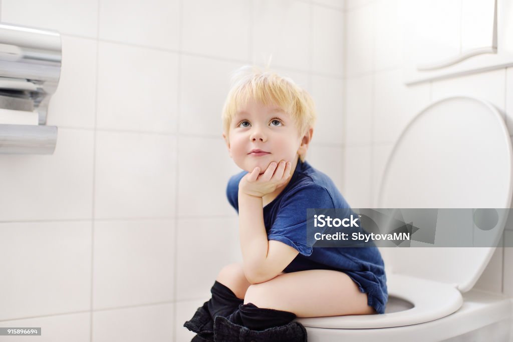 Cute little boy in restroom Cute little boy in restroom. Toddler child trainig use toilet. Hygiene for little child Child Stock Photo