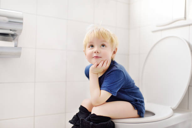 Cute little boy in restroom Cute little boy in restroom. Toddler child trainig use toilet. Hygiene for little child potty toilet child bathroom stock pictures, royalty-free photos & images