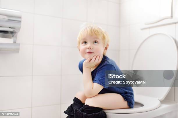 Cute Little Boy In Restroom Stock Photo - Download Image Now - Child, Toilet, Bathroom