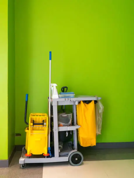 Cleaning tools cart wait for cleaning.Bucket and set of cleaning equipment in the office. janitor service janitorial for your place. Concept of service, worker and  equipment for cleaner and health