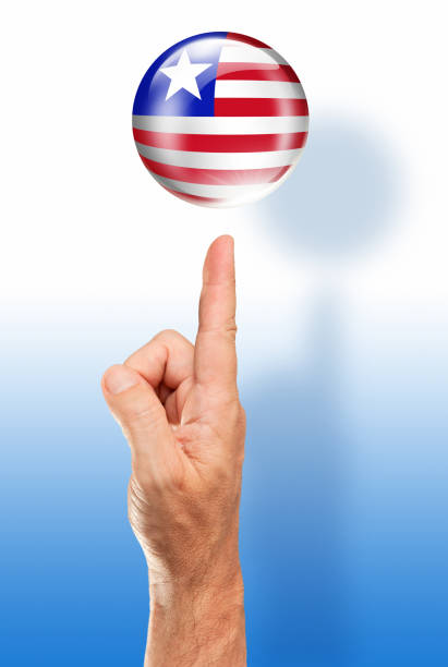 istock Liberia button flag pointing with human hand 915900542