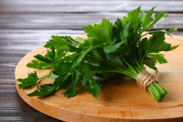 istock Fresh green parsley on the wooden table, selective focus. 915900974