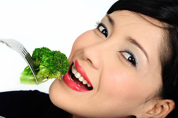 istock Young asian girl eating broccoli 91590208