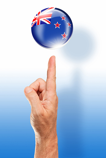 New Zealand button flag pointing with human hand