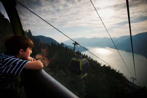 Boy in cable car in Squamish looking down.