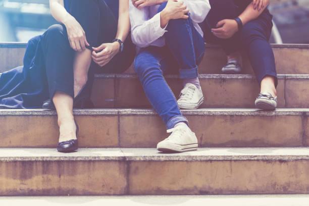 istock three friends sit relax on public stair travel concept 915911592
