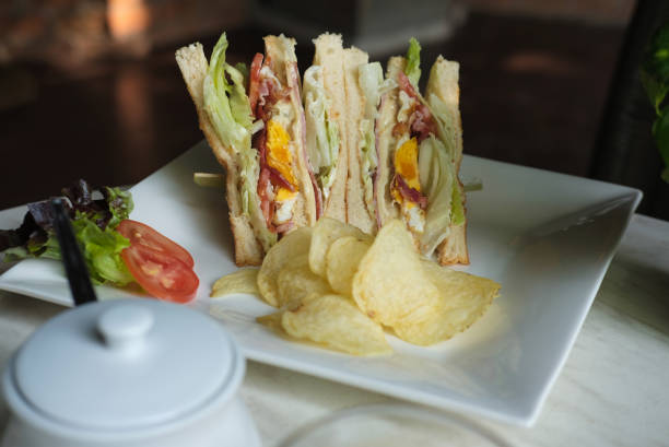 istock fresh sandwich with bread, tomato, lettuce & cheese. tasty appetizer on white dish. 915911680