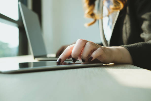 istock businesswoman using tablet computer at workplace. startup woman working with computer at office.  young female entrepreneur analyze accounting market data. 915911730