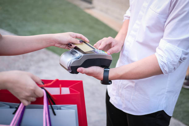 istock man make payment with credit card swipe through terminal. customer paying & entering code with EDC or swiping machine. buy & sell product or service 915911774