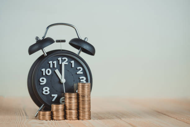 istock Steps of coins stack with vintage alarm clock on wooden working table with copy space for text, financial and business planning concept. vintage tone. 915911904