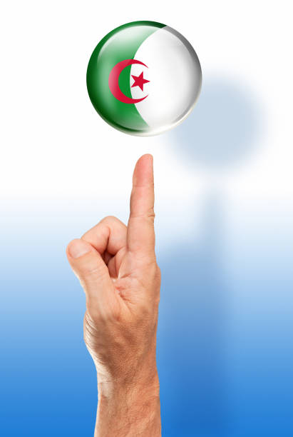 Algeria button flag pointing with human hand Algeria button flag pointing with human hand algeria soccer stock pictures, royalty-free photos & images