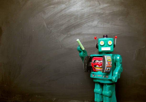 istock Big  cyan blue robot toy teaches his class 915921008