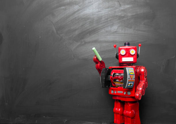 große rote roboter spielzeug lehrt seine klasse, - blackboard writing chalk teacher stock-fotos und bilder