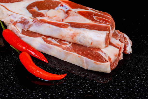 istock Raw lamb steak, in front of a pile of bones 915925940