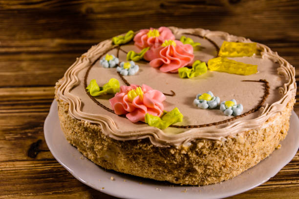 istock Kiev cake with cream on wooden table 915930396