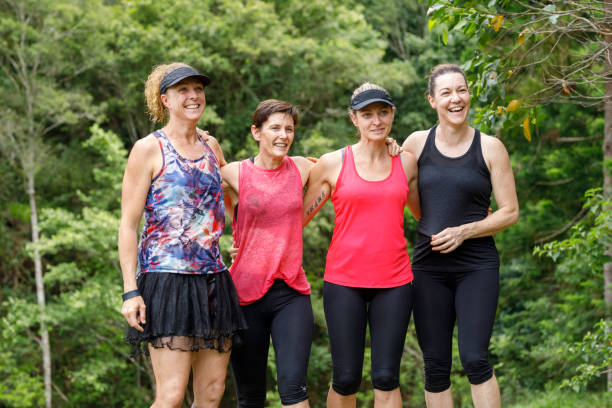 istock Mature Age Female Friends Celebrating After Completing Fun Run 915937116