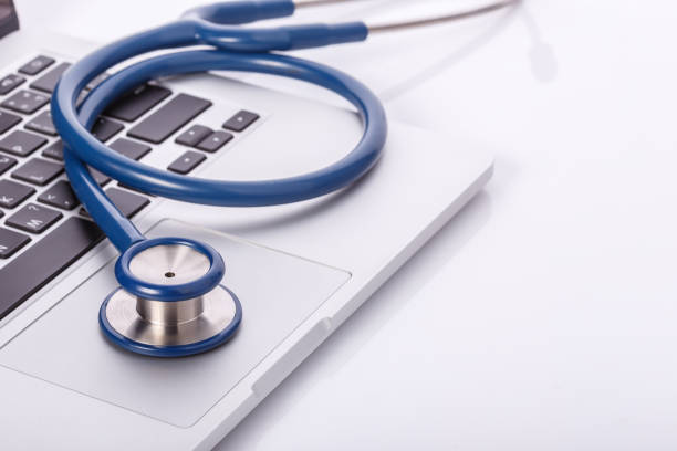 istock Computer notebook or laptop and stethoscope. Checking virus or damaged check up concept. 915937780