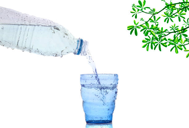 cool fresh drinking water bottle flowing to blue glass - fressness imagens e fotografias de stock