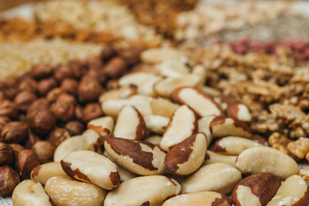 Nuts mix in a canvas bag in table. Ten kinds of nuts: pecan, brazil, cedar, sunflower, hazelnut, almond, peanut walnut pistachio cashew