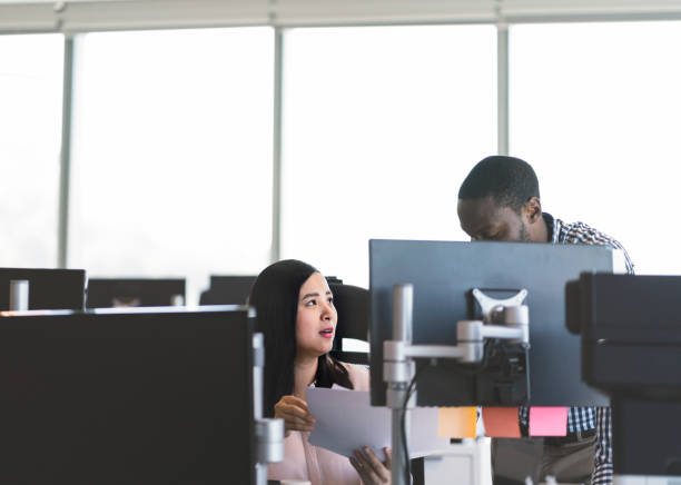 istock Businessman discussing with colleague in office 915947130