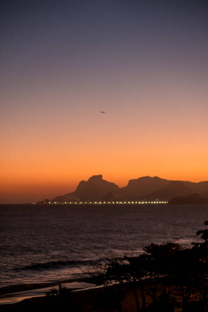 istock beautiful orange sunset in Itacoatiara beach, rio de janeiro 915947464