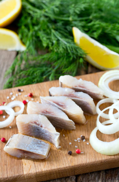 istock herring onion and herbs on wooden surface 915952750