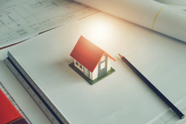 istock Architect design concept. Model house and Pencil drawing on blueprint. Engineering concept. 915959522