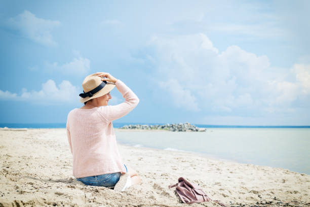 istock woman posing against the sea 915959590