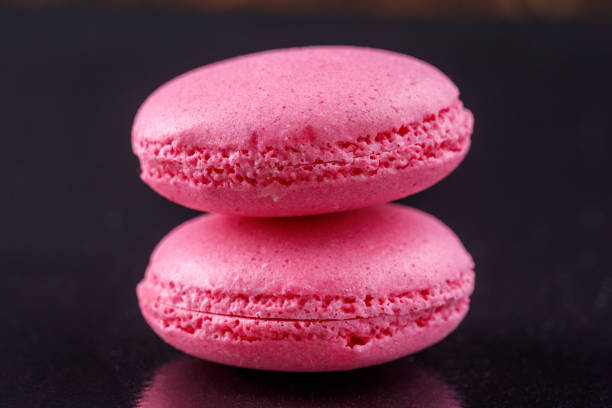 istock A pair of soft pink macaroons on a black background. 915959710