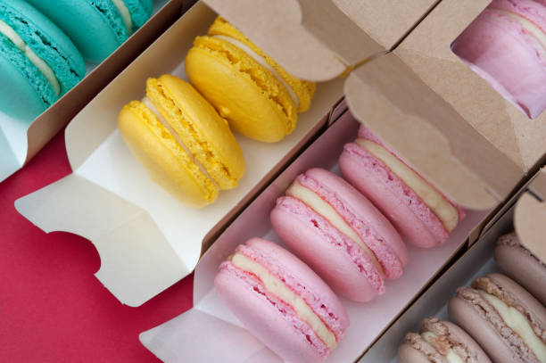 istock Set of different pastel macaroons in paper boxes 915959828