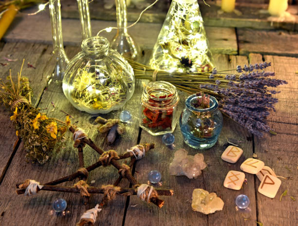 istock Magic ritual objects collection with pentagram, runes, bottles and herbs 915962444