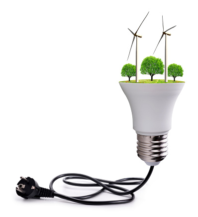 Wind turbines and trees in LED bulb with electric plug isolated on white background.Saving lamp. Green energy theme.