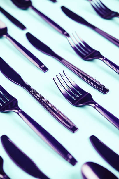 istock Ultra violet still life. Purple plastic cutlery background 915969602