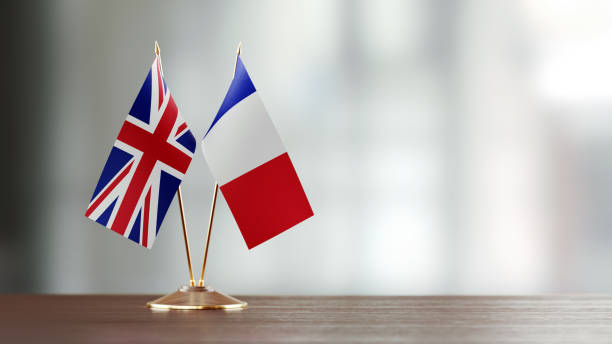 istock French And British Flag Pair On A Desk Over Defocused Background 915974566