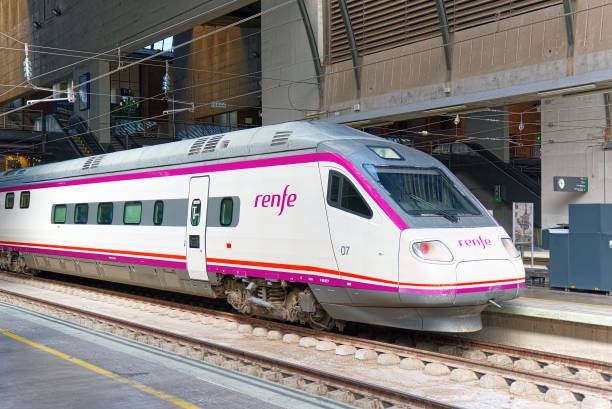 Modern hi-speed passenger train of Spanish railways company-Renfe, on Seville railways station Sevilla Santa Justa. Seville, Spain - June 08, 2017 : Modern hi-speed passenger train of Spanish railways company-Renfe, on Seville railways station Sevilla Santa Justa. seville port stock pictures, royalty-free photos & images