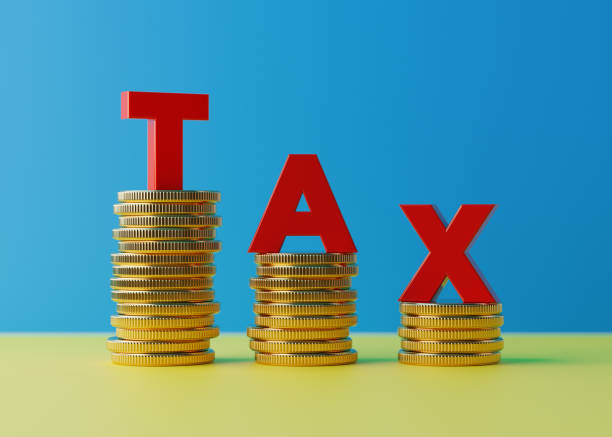 istock Red Letters Standing On Coin Stacks Forming Tax Word 915975172