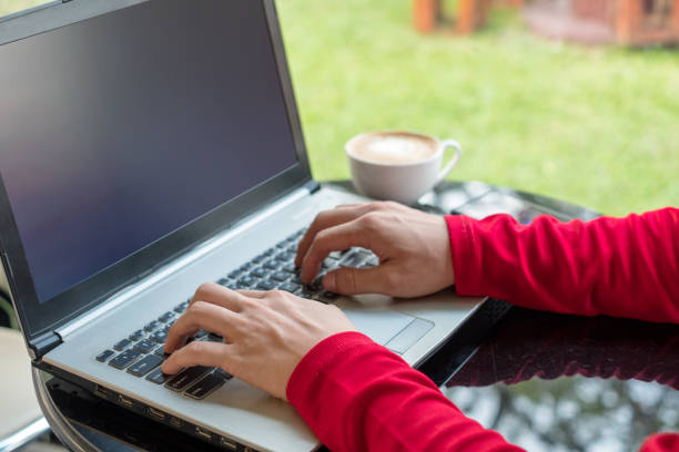istock Casual man typing with laptop and drinking coffee 915981282