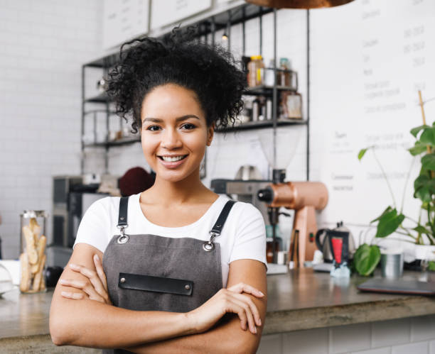 istock Cafe owner standing with arms crossed looking at camera 915984792