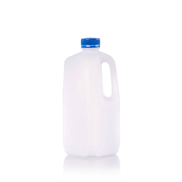 istock Clear blank empty milk bottle with blue cap. Studio shot isolated on white 915985870