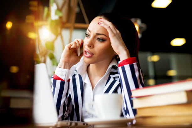 istock Beautiful woman talking over phone being busy with work 915992626