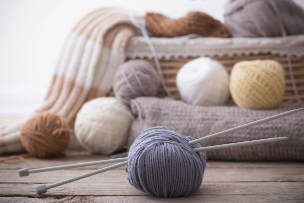 istock Knitting and knitting needles on a wooden surface 915992656