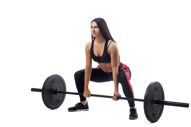 istock woman doing squat with barbell 915995516