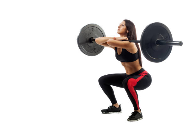 istock woman doing squat with barbell 915995700