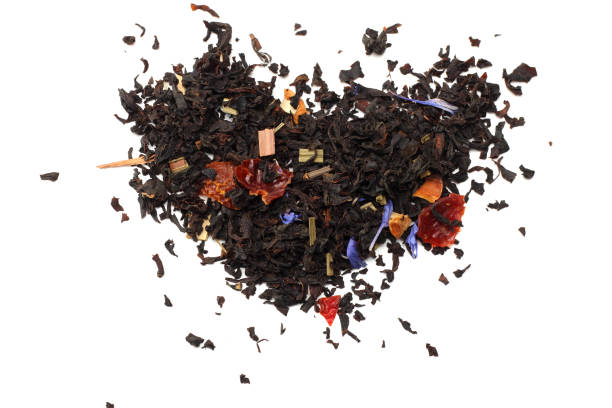 istock Aromatic black dry tea with petals isolated on white background top view 915995898
